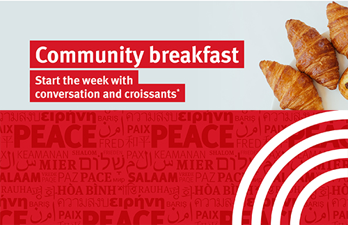 Start the week with conversation a croissants. Plate of croissants above a banner with the word 'Peace' written in many different languages.